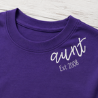 Established Script & Sleeve Names Long-Sleeve Tee. Curved-neck embroidery. Shown in: Gildan • Purple.