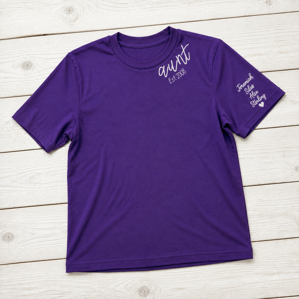 Established Script & Sleeve Names Tee. Curved-neck embroidery. Shown in: Gildan • Purple.