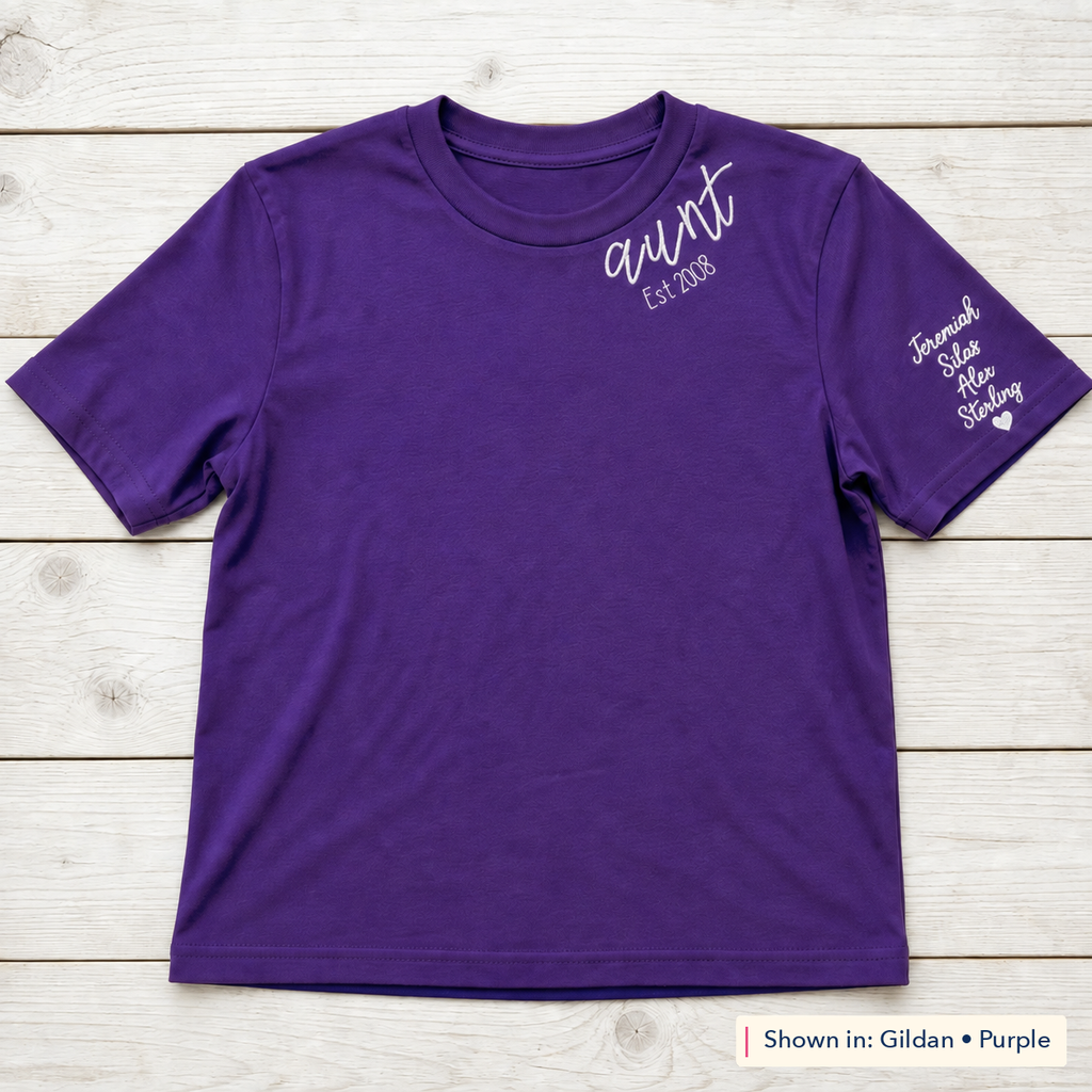 Established Script & Sleeve Names Tee. Curved-neck embroidery. Shown in: Gildan • Purple.