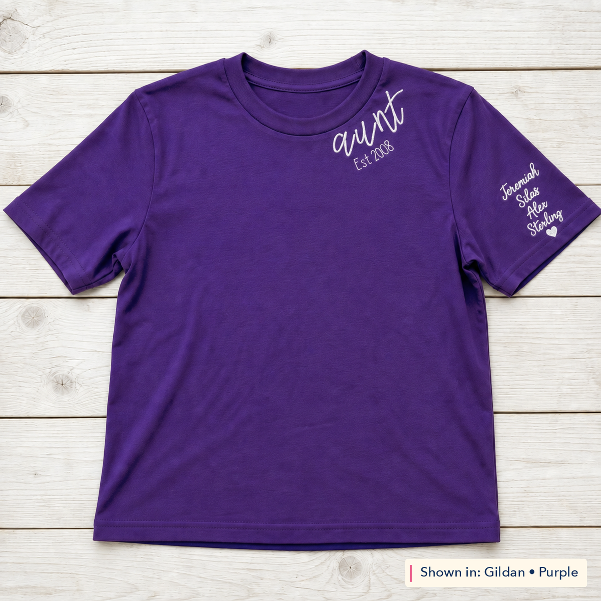 Established Script & Sleeve Names Tee. Curved-neck embroidery. Shown in: Gildan • Purple.