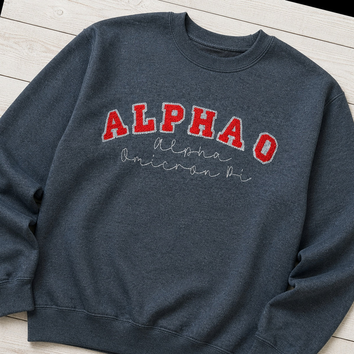 arched varsity script crewneck styled flat lay