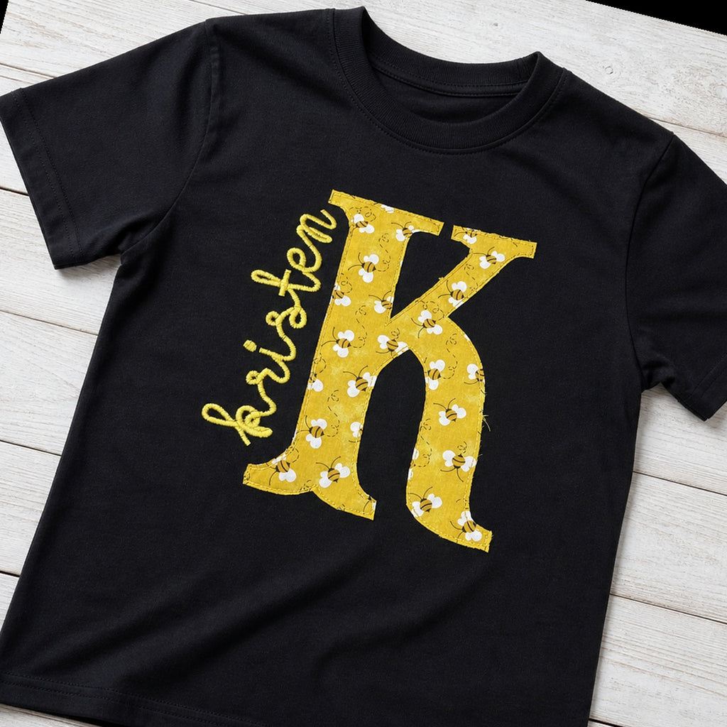 bee initial name short sleeve styled flat lay