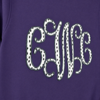Close-up of black dot vine monogram applique on Gildan 18000 Purple sweatshirt