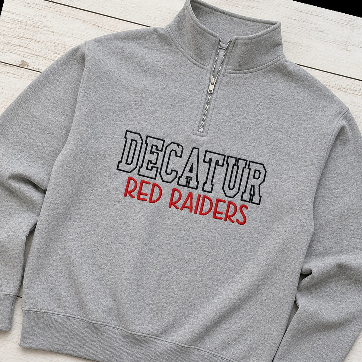 block outline team name quarter zip styled flat lay