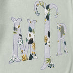 Close-up of the embroidered design on a custom botanical floral serif monogram crewneck sweatshirt