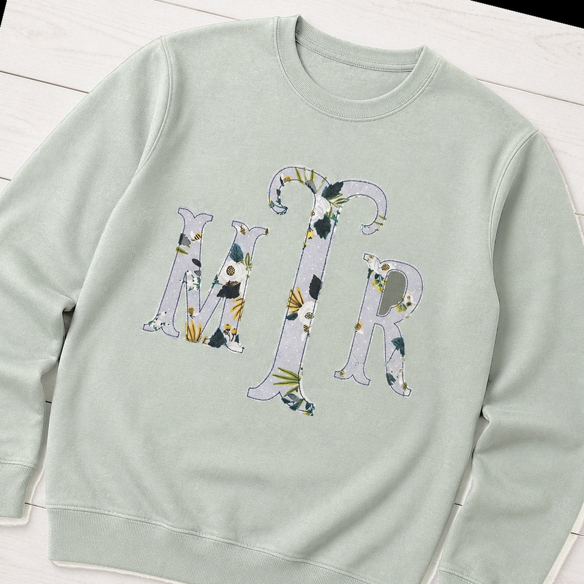 Custom botanical floral serif monogram crewneck sweatshirt folded flat lay