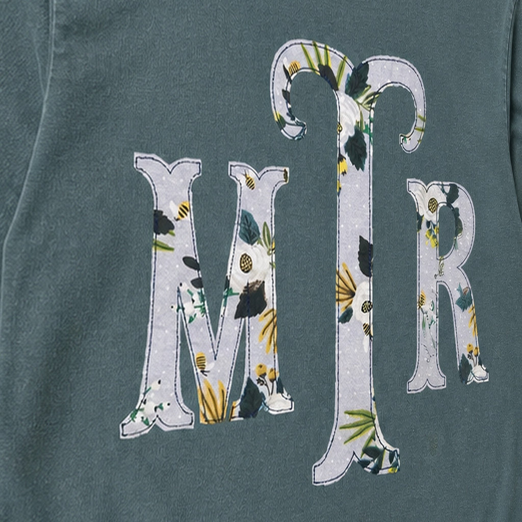 Close-up of the embroidered design on a custom botanical floral serif monogram long sleeve shirt