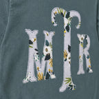 Close-up of the embroidered design on a custom botanical floral serif monogram long sleeve shirt