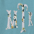 Close-up of the embroidered design on a custom botanical floral serif monogram quarter zip pullover