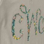 Close-up of the embroidered design on a custom floral vine monogram quarter zip pullover