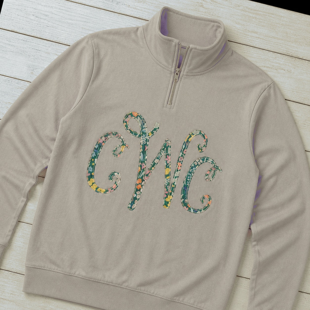 Custom floral vine monogram quarter zip pullover folded flat lay