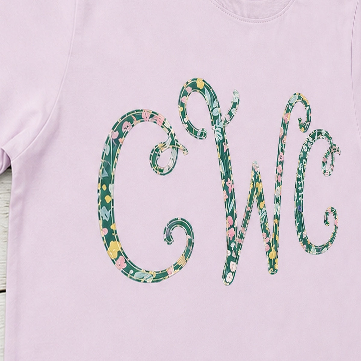 Close-up of the embroidered design on a floral vine monogram shirt