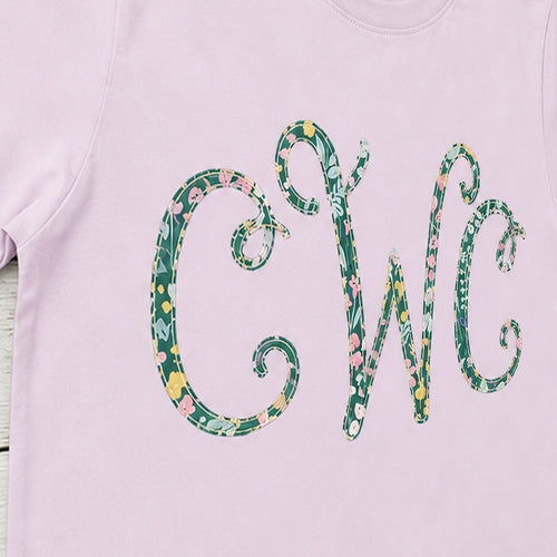 Close-up of the embroidered design on a floral vine monogram shirt