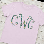 Floral vine monogram shirt folded flat lay