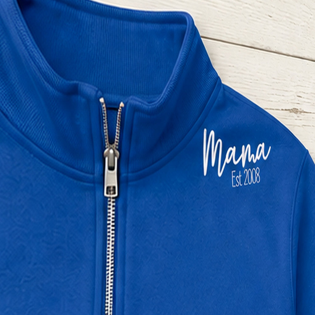 Close-up of the embroidered design on a mama established quarter zip with sleeve names