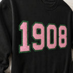 Close-up of the embroidered design on a 1908 faux chenille glitter crewneck sweatshirt