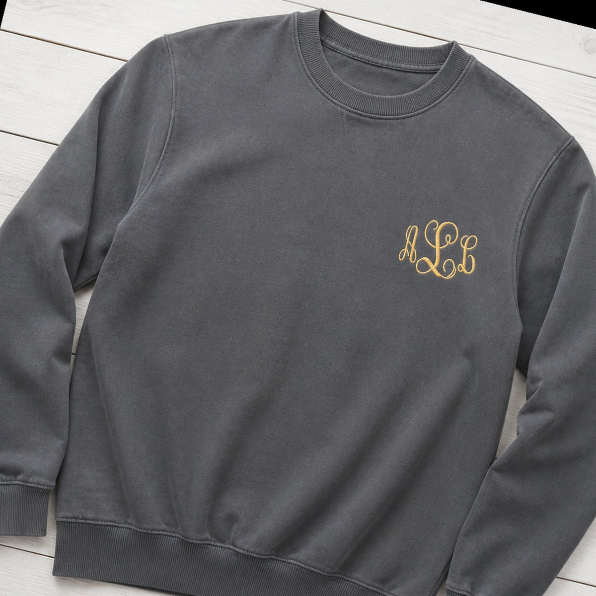 gold script pocket monogram crewneck styled flat lay