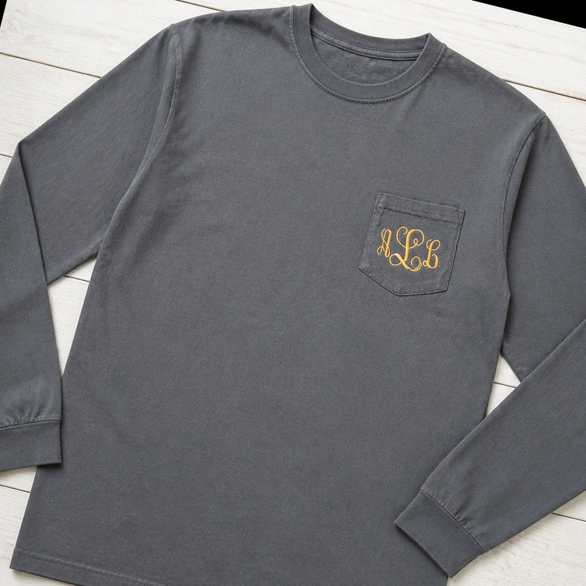 gold script pocket monogram long sleeve styled flat lay