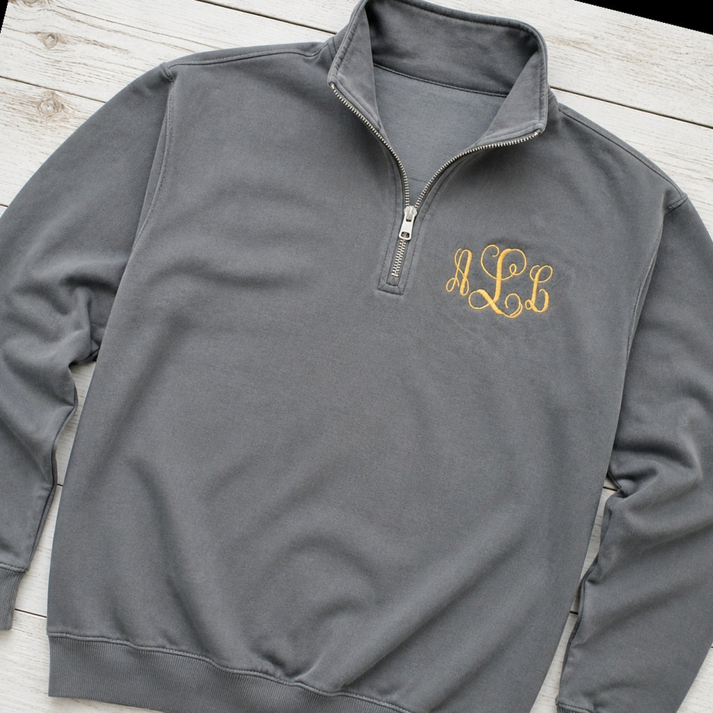 gold script pocket monogram quarter zip styled flat lay