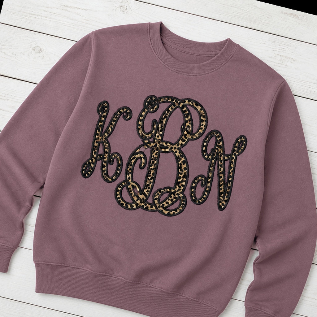 Custom leopard vine monogram crewneck sweatshirt folded flat lay
