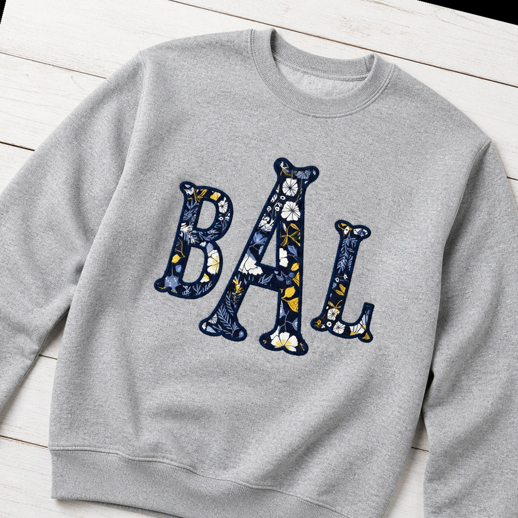 navy floral block monogram crewneck styled flat lay