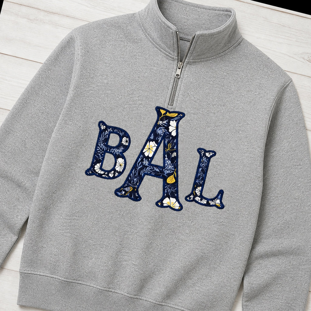navy floral block monogram quarter zip styled flat lay