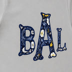 navy floral block monogram short sleeve embroidery close-up