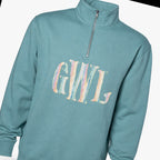 pastel stripe serif monogram quarter zip styled flat lay