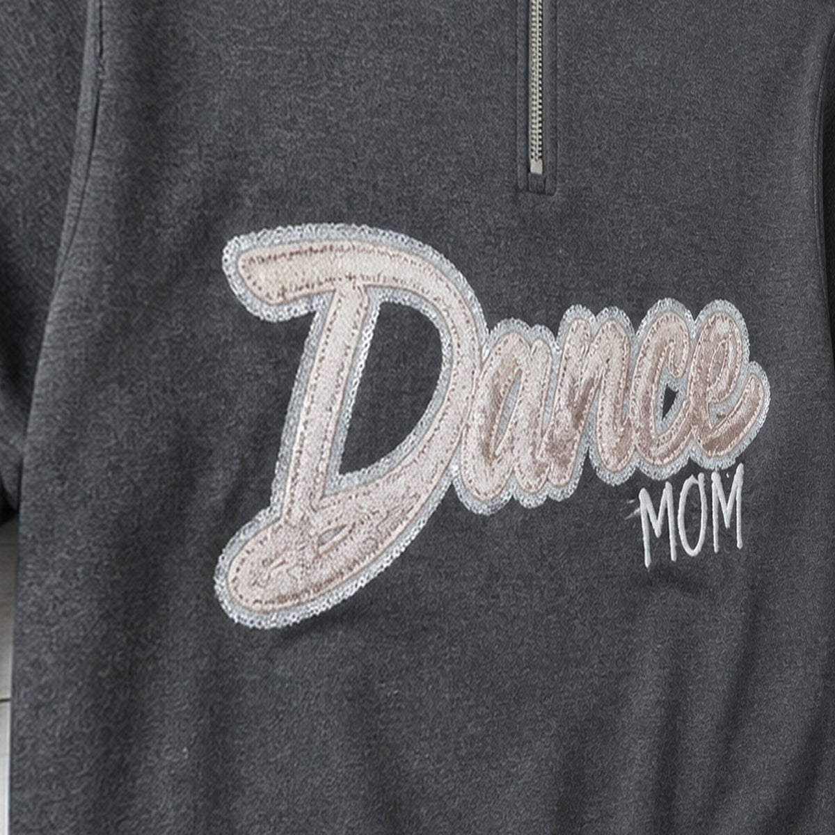 script glitter sequin quarter zip embroidery close-up