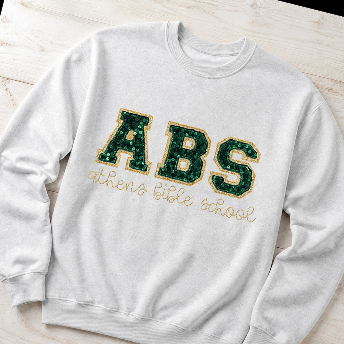 Custom sequin varsity crewneck sweatshirt folded flat lay