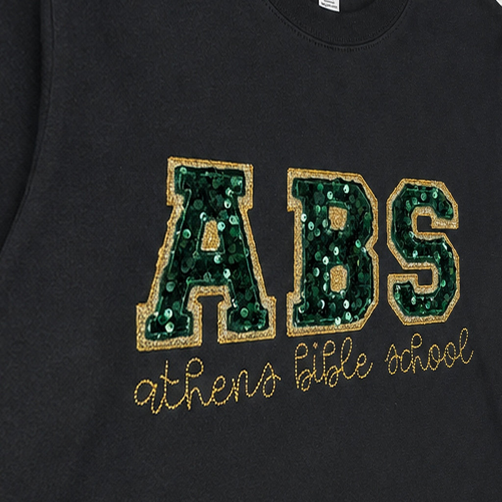 Close-up of the embroidered design on a custom sequin varsity long sleeve shirt