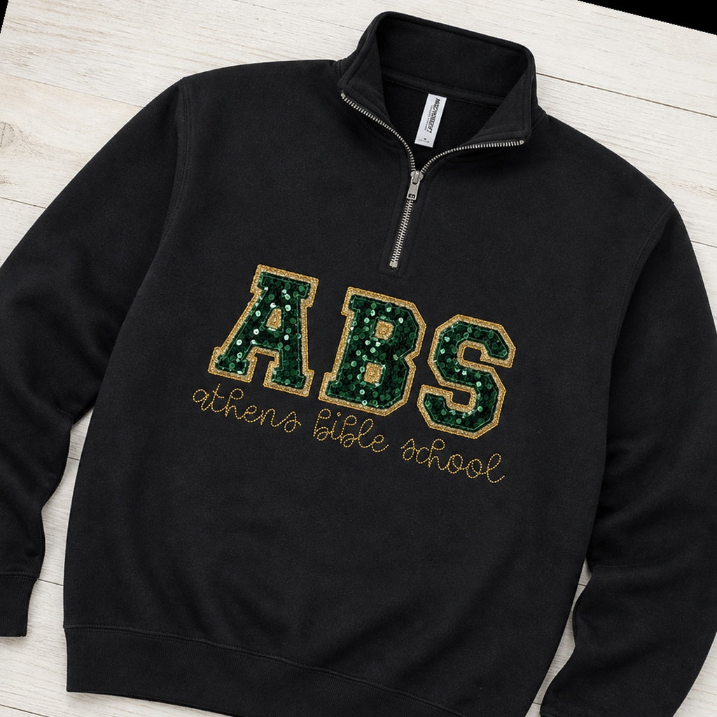 Custom sequin varsity quarter zip pullover folded flat lay