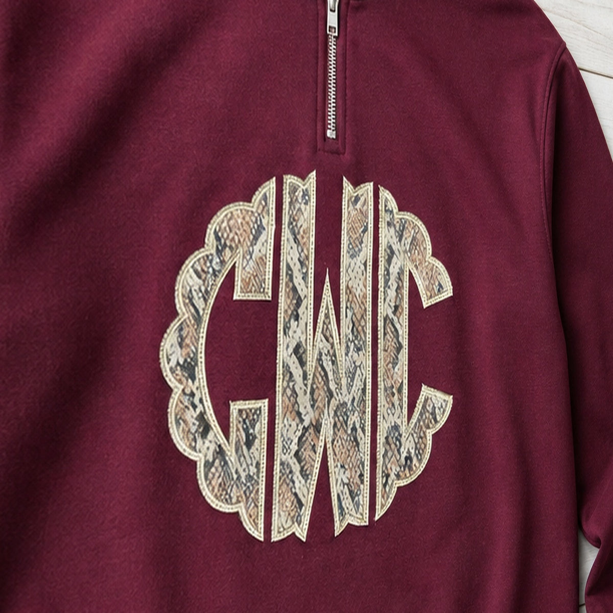 snakeskin scallop monogram quarter zip embroidery close-up