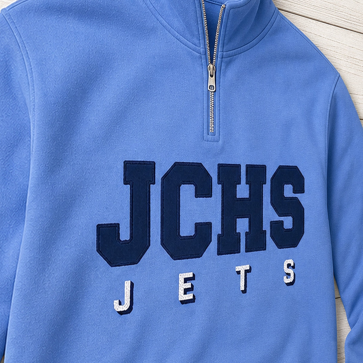team lettering back name quarter zip embroidery close-up