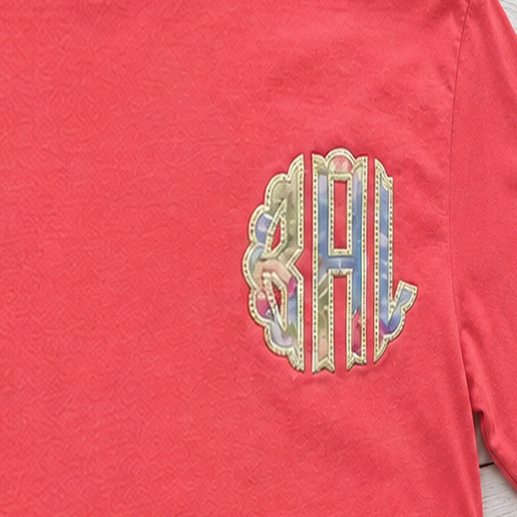 Close-up of the embroidered design on a custom pastel stripe chest monogram long sleeve shirt