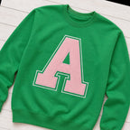 varsity initial crewneck styled flat lay