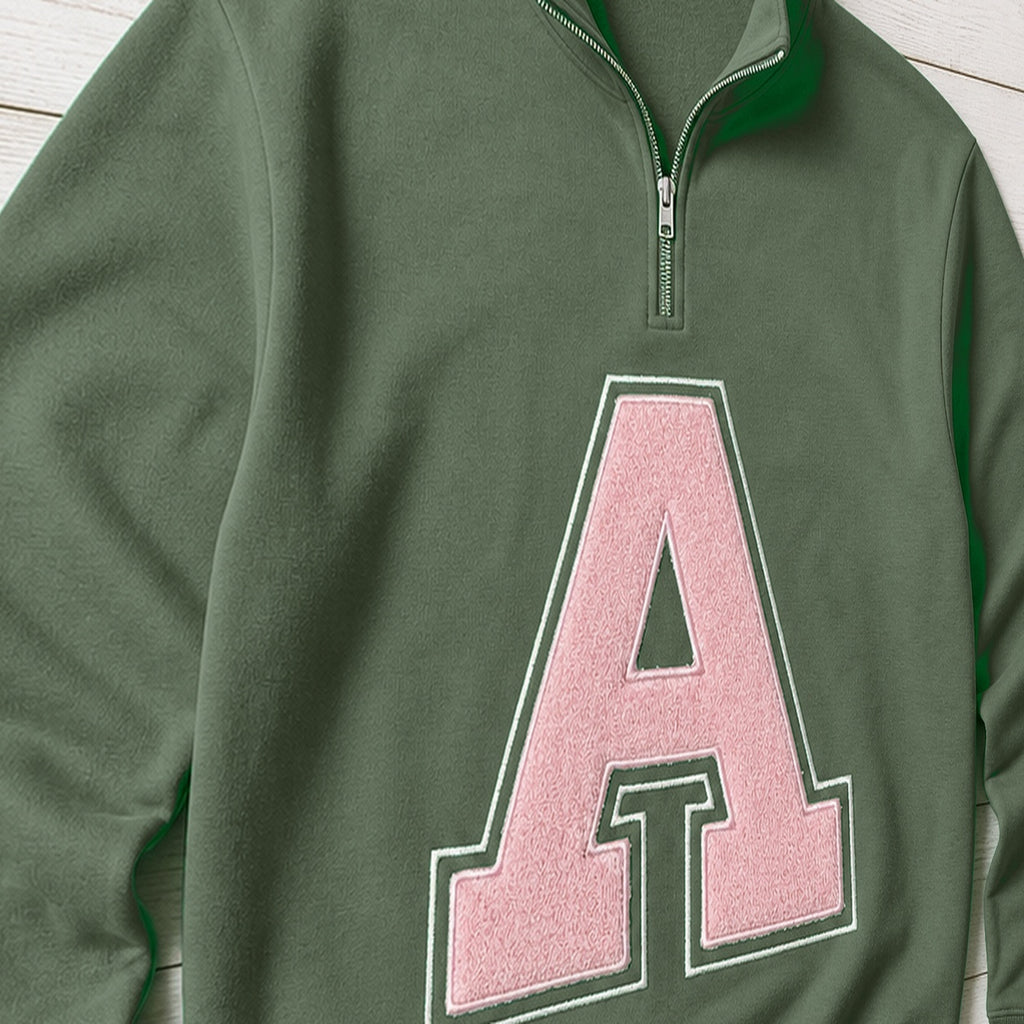 Close-up of the embroidered design on a custom varsity initial applique quarter zip pullover