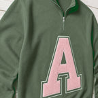 Close-up of the embroidered design on a custom varsity initial applique quarter zip pullover