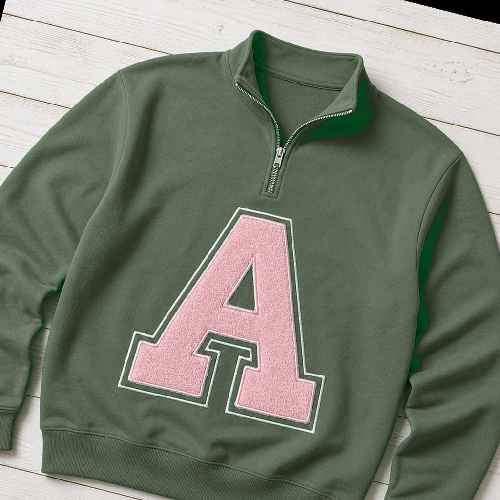 Custom varsity initial applique quarter zip pullover folded flat lay