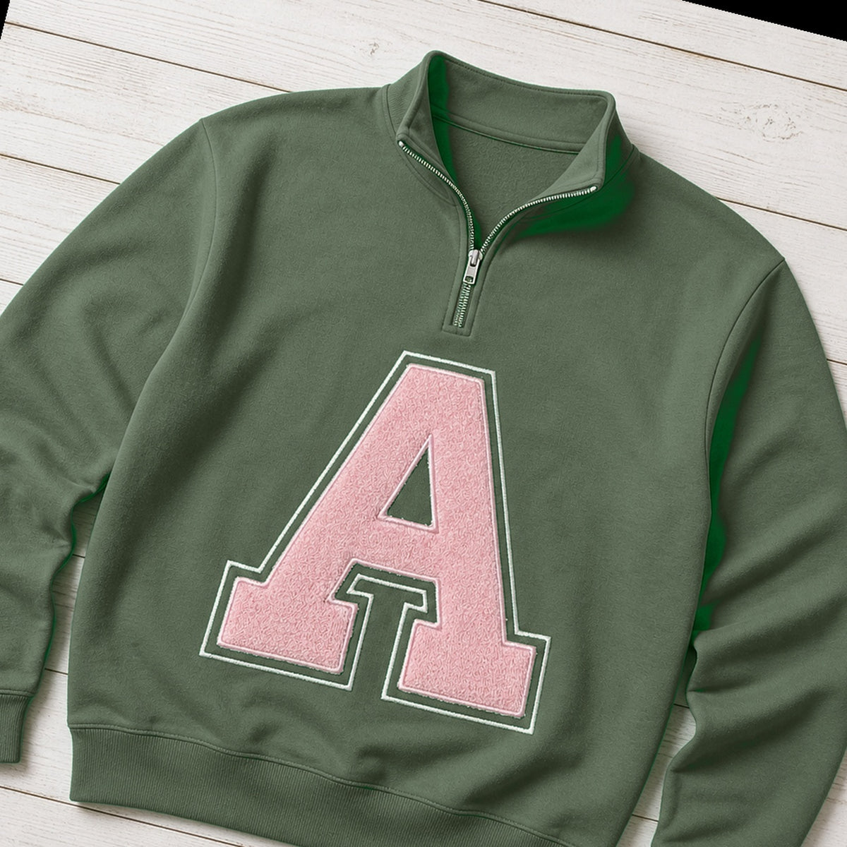 Custom varsity initial applique quarter zip pullover folded flat lay