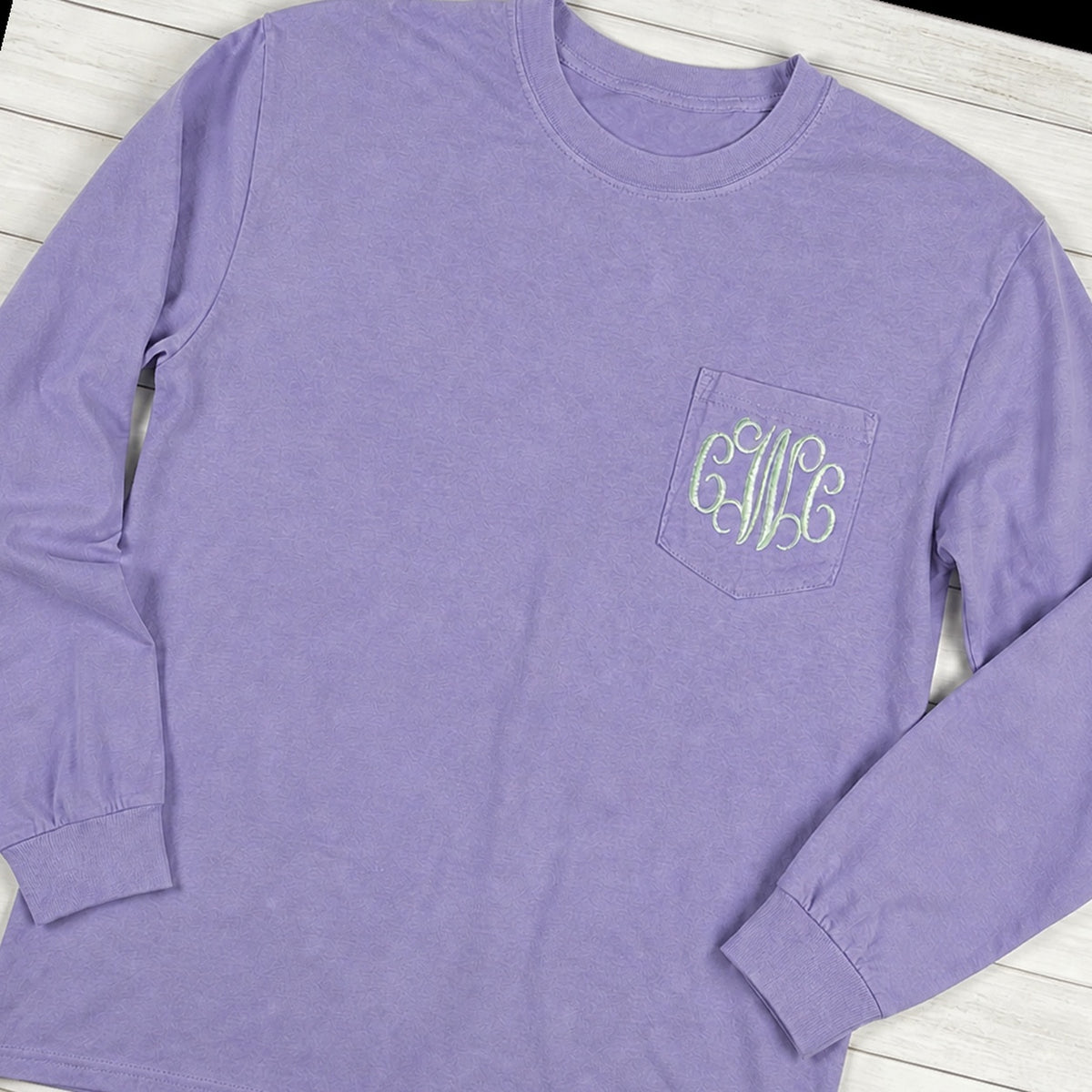 Custom vine monogram long sleeve pocket tee folded flat lay